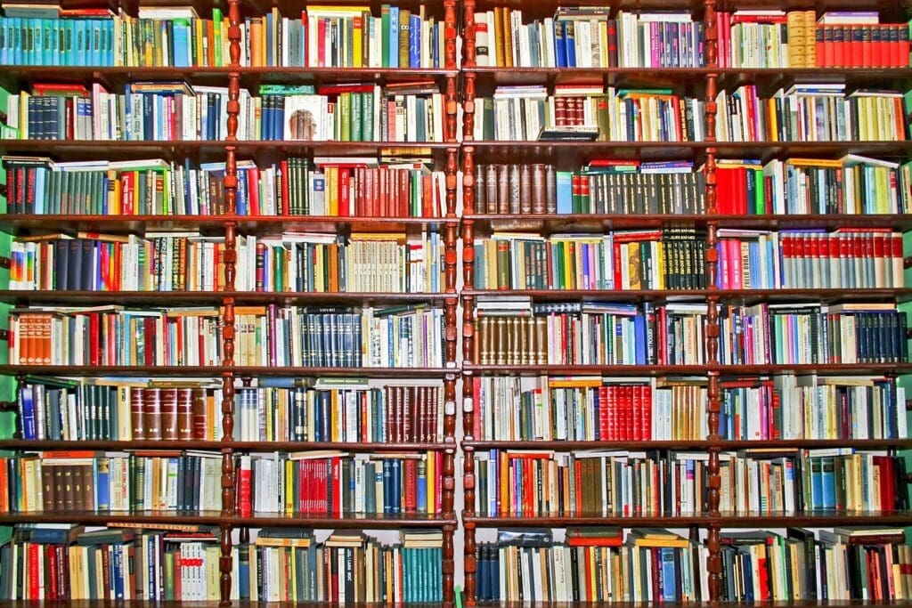 A tall bookshelf filled with colorful books.